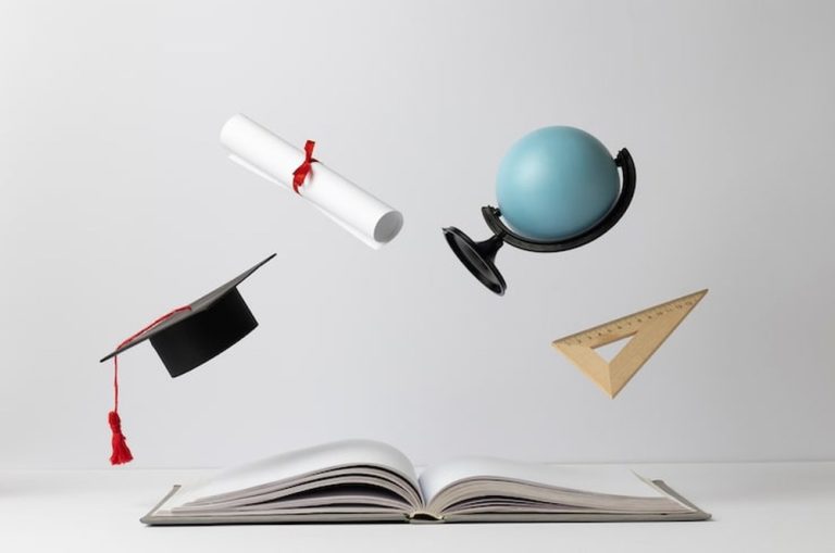 front view of an open book, a graduation cap, a diploma, an earth globe and a triangle for education day